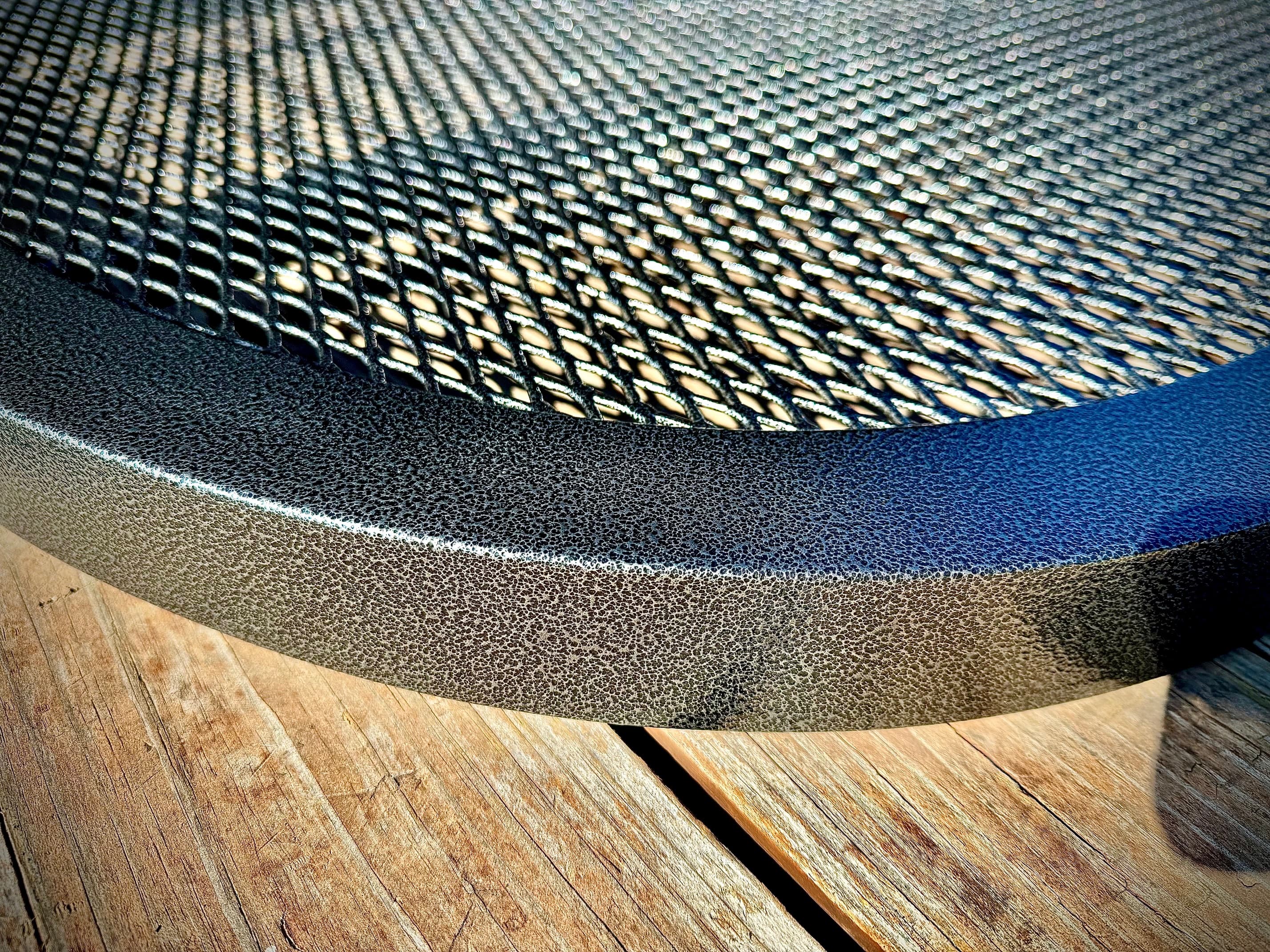Detail shot of mesh grate pattern and textured surface